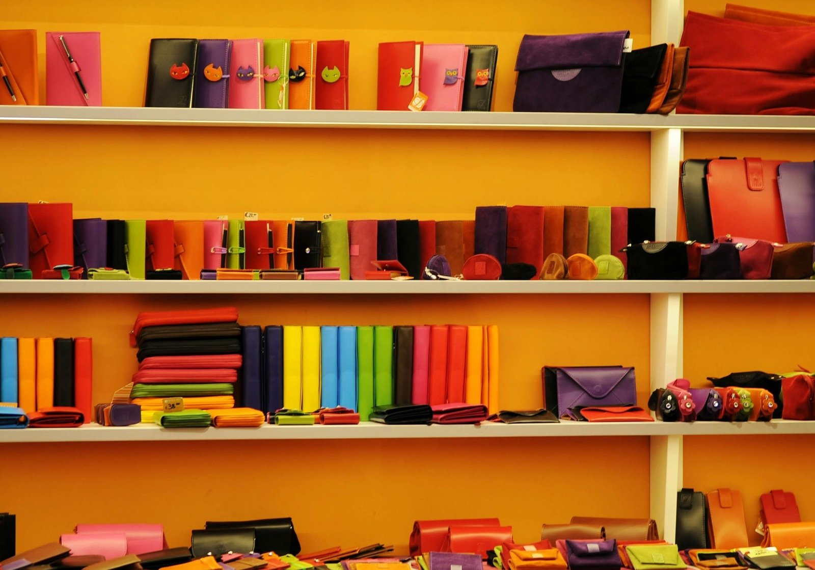 Vibrant assortment of wallets and bags displayed on retail shelves.